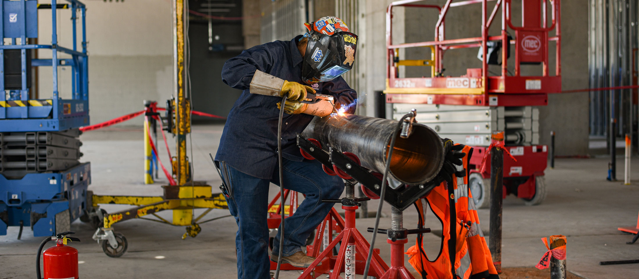 Kaylin Leas Welding a pipe.
